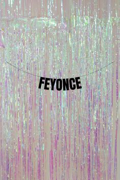 a string with the word fefonce hanging from it's center surrounded by streamers