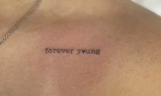 the back of a man's chest with an inscription on it that says forever young