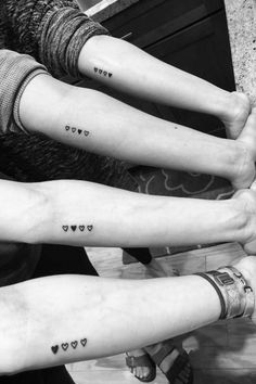 three people with small tattoos on their arms