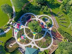 an aerial view of a park with lots of trees and plants in the middle of it