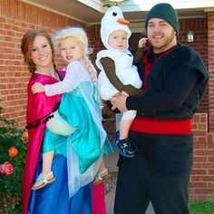 two adults and one child dressed up as frozen princesses