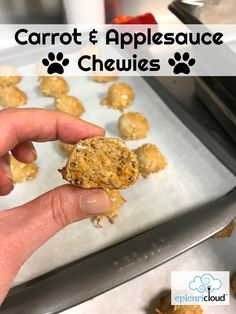 a hand holding a cookie in front of some cookies on a baking sheet with the words carrot and applesauce chews