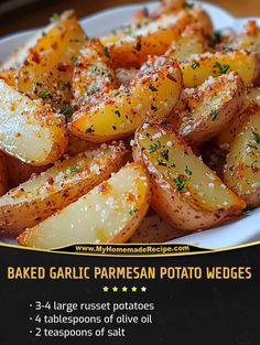 baked garlic parmesan potato wedges on a white plate