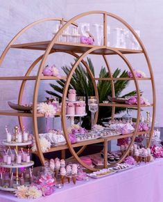 a table topped with lots of cakes and cupcakes