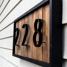 a house number sign mounted to the side of a building