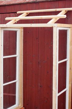 an open window on the side of a red building