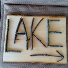 the word fake is made out of branches on a wooden board with scissors in it