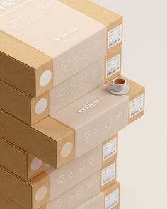 four boxes stacked on top of each other with a cup in the middle one is empty