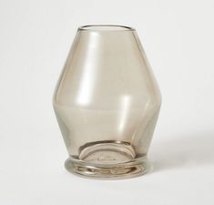 a glass vase sitting on top of a white table