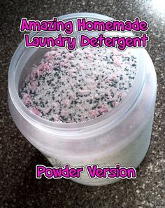 the container is full of powdered white and black stuff with pink writing on it