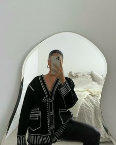 a man taking a selfie in front of a mirror with his reflection on it