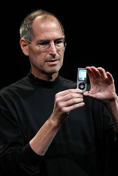 steve jobs holding an ipod in his right hand