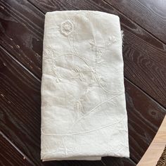 a white towel sitting on top of a wooden table