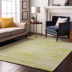 a living room filled with furniture and a green rug on top of a hard wood floor