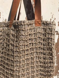 "This is a lovely natural linen tote bag made from rustic linen base, with a decorative linen weave on front and natural leather straps. 100% pure European linen. Simple and free, all natural. Will add a lovely boho touch to your outfit. The color is natural linen taupe - a tone between beige and grey - it is the natural color of undyed linen. Approximate dimensions: 16\" (41cm) wide and 17\" (44 cm) tall, 3.5\" (9cm) wide on sides and the leather straps measure 27.5\" (70cm) in full-length so t Handmade Natural Canvas Bag For Everyday Use, Rectangular Natural Canvas Straw Bag, Natural Rectangular Canvas Straw Bag, Neutral Handwoven Bag For Everyday Use, Neutral Handwoven Bag For Daily Use, Rustic Handmade Bags For Everyday Use, Neutral Woven Jute Bag, Woven Burlap Tote Straw Bag, Natural Tote Canvas Bag With Braided Handles