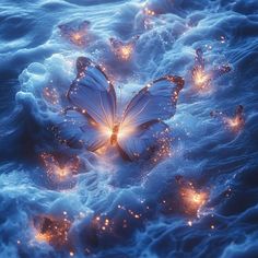 a group of butterflies floating on top of waves in the ocean with glowing lights around them