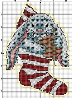 a cross stitch pattern with a bunny holding a christmas stocking in it's paws