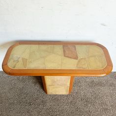 a wooden table sitting on top of a carpeted floor