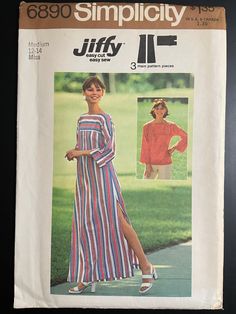 a woman in a striped dress is standing next to a green field and has her hand on her hip