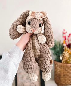 a person holding a stuffed animal in their hand