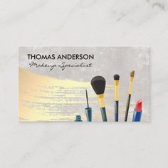 a business card with makeup brushes on it