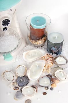 several seashells and candles are on the table