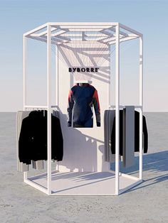 an open white display case with clothes on hangers in front of it and the words byborrt written across the top