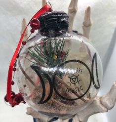 a glass ornament with an image of a fish on it's side