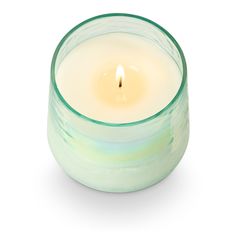 a lit candle sitting in a glass container