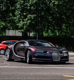 a bugatti car parked in a parking lot next to other cars