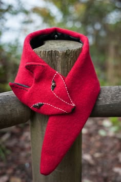 a close up of a red scarf on a wooden post