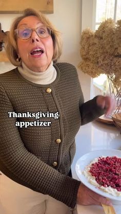 a woman holding a plate with food on it and the words thanksgiving appetizer in front of her