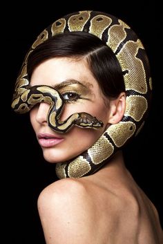 a woman with a snake on her face