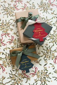 three wrapped presents sitting on top of a table