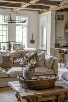 a living room filled with furniture and lots of windows