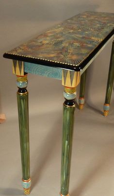 a table with two legs and a painted top