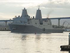 a large ship in the water next to a dock