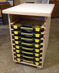 a garage workbench with yellow and black tools on the top, in front of it