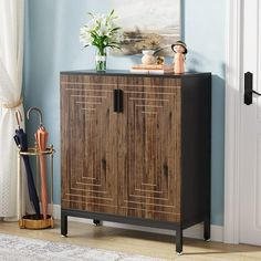 a wooden cabinet sitting on top of a hard wood floor next to a white door