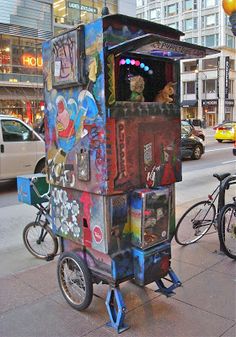 a street scene with focus on an old fashioned vending machine