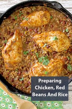 chicken, rice and beans in a skillet with a wooden spoon next to it