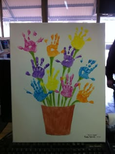 an art project with handprints of flowers in a pot