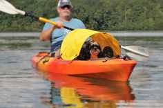 a man and woman are kayaking on the water