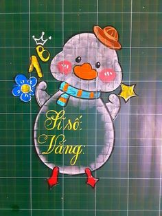 a drawing of a snowman on the side of a green tile wall with words written in spanish