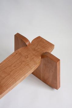 a wooden bench sitting on top of a white surface