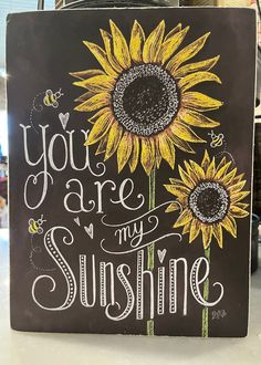 a chalkboard sign that says you are my sunshine with two sunflowers on it