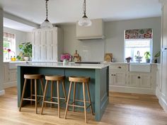 two stools sit at the center of this kitchen island