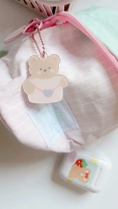 a pink bag with a teddy bear tag on it