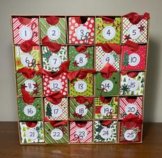 a wooden box filled with lots of different types of christmas cards and numbers on it