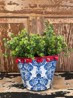 a blue and white flower pot sitting on top of a table